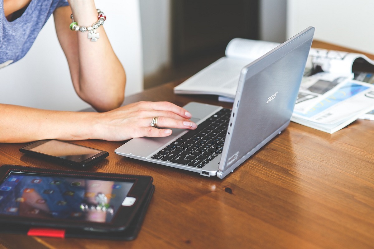 Person typing on a laptop keyboard